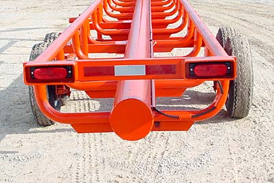 Orange Ox - Orange Ox Self Un-loading Hay Trailers - The tail lights are protected by heavy box tubing and the wiring is protected by schedule 40 pipe. This picture also shows the one piece els (no welds to break), reinforced by  x 2 flat steel.